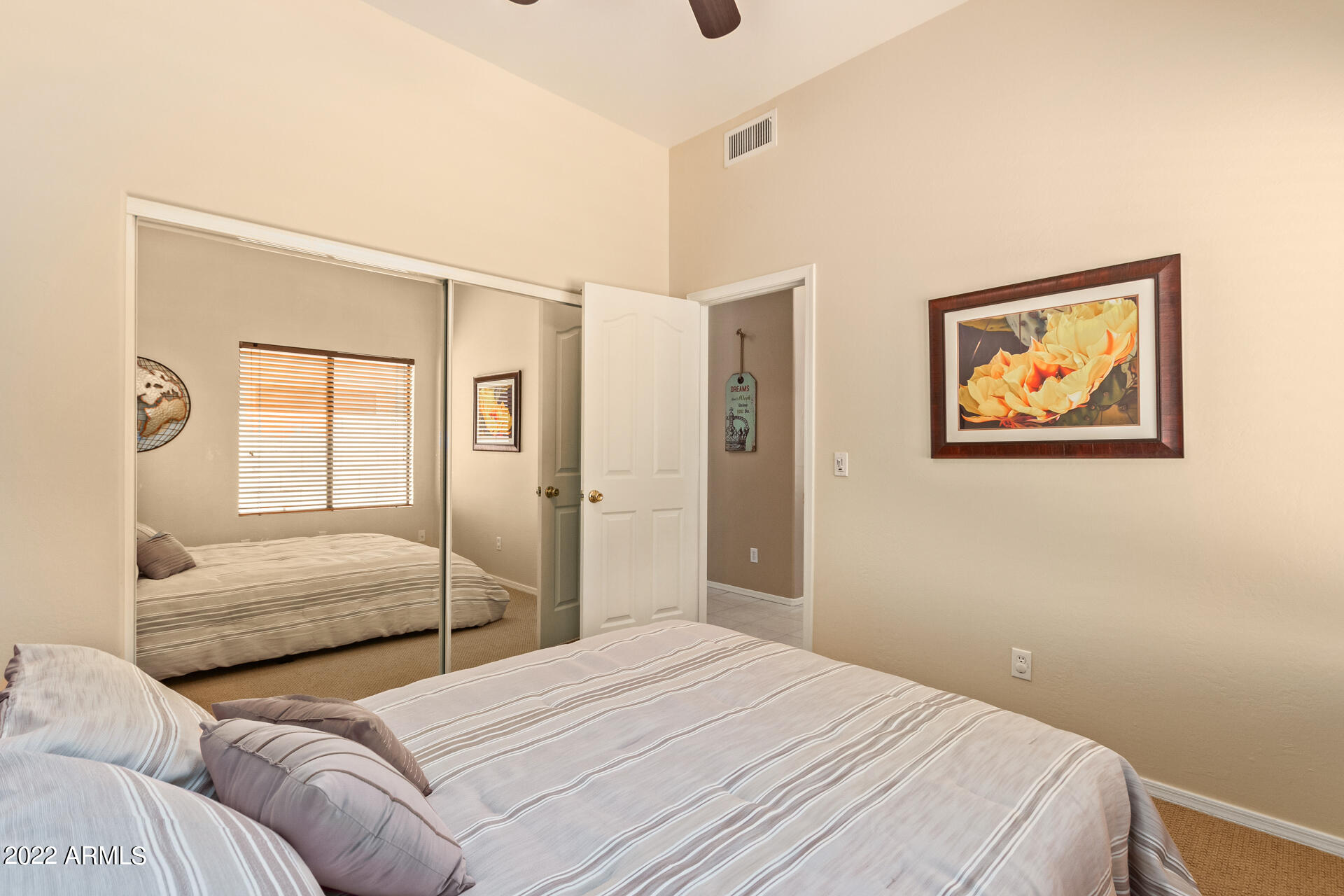 4515 East Jaeger Road Phoenix, AZ 85050 - Photo 18 of 27 a bedroom with a large bed and a chandelier