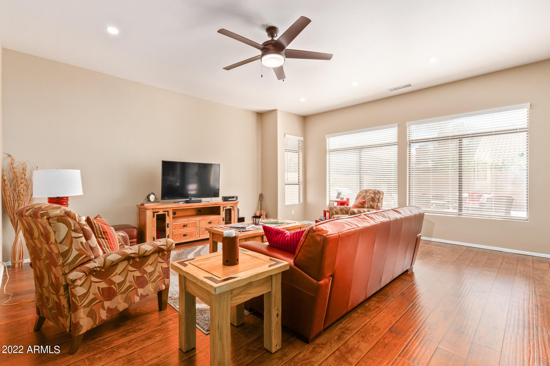 4515 East Jaeger Road Phoenix, AZ 85050 - Photo 7 of 27 a living room with furniture a flat screen tv and a large window