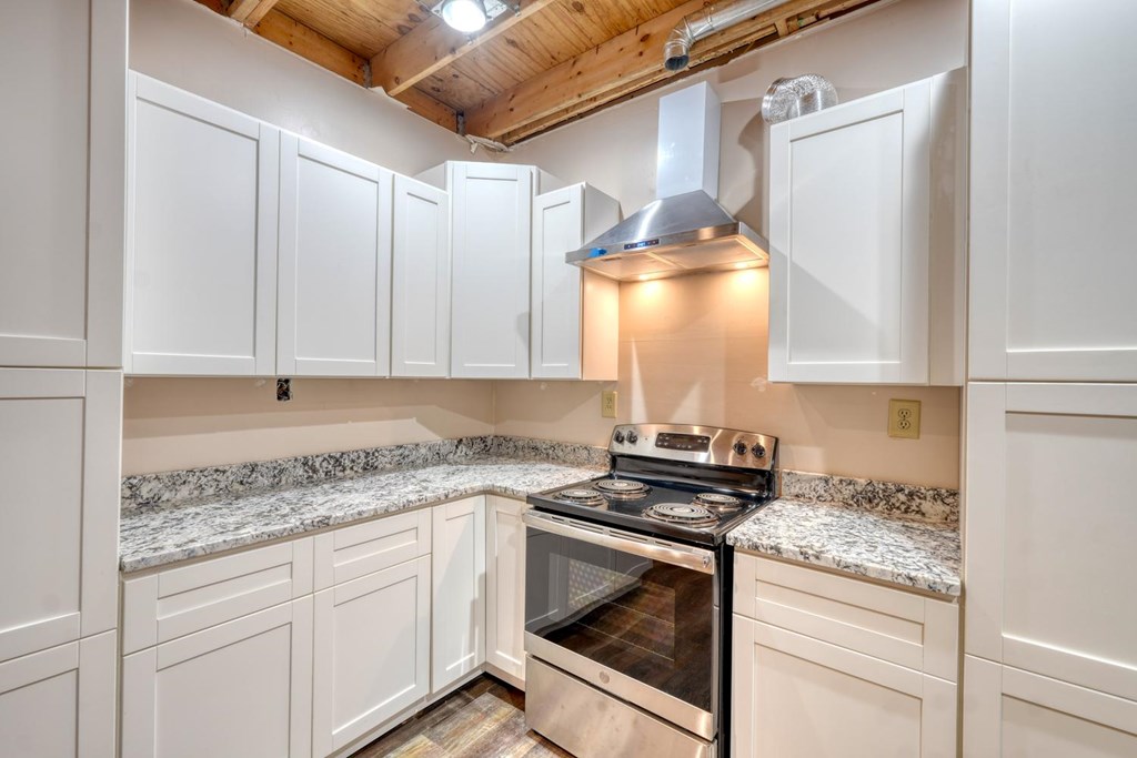 1066 Ridge Road Hiawassee, GA 30546 - Photo 13 of 51 a kitchen with granite countertop white cabinets and white appliances