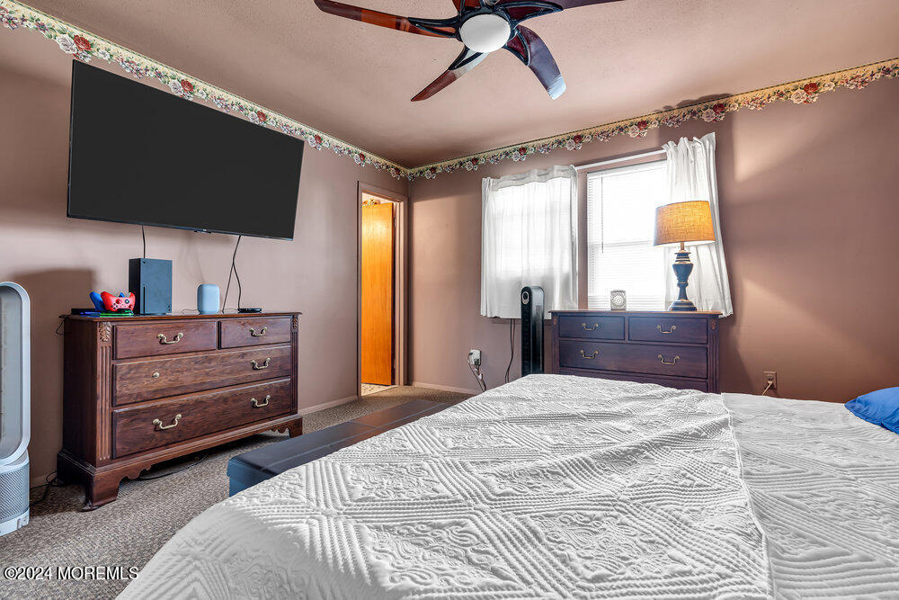 115 Stillwells Corner Road Freehold, NJ 07728 - Photo 26 of 47 a bedroom with a bed and flat screen tv