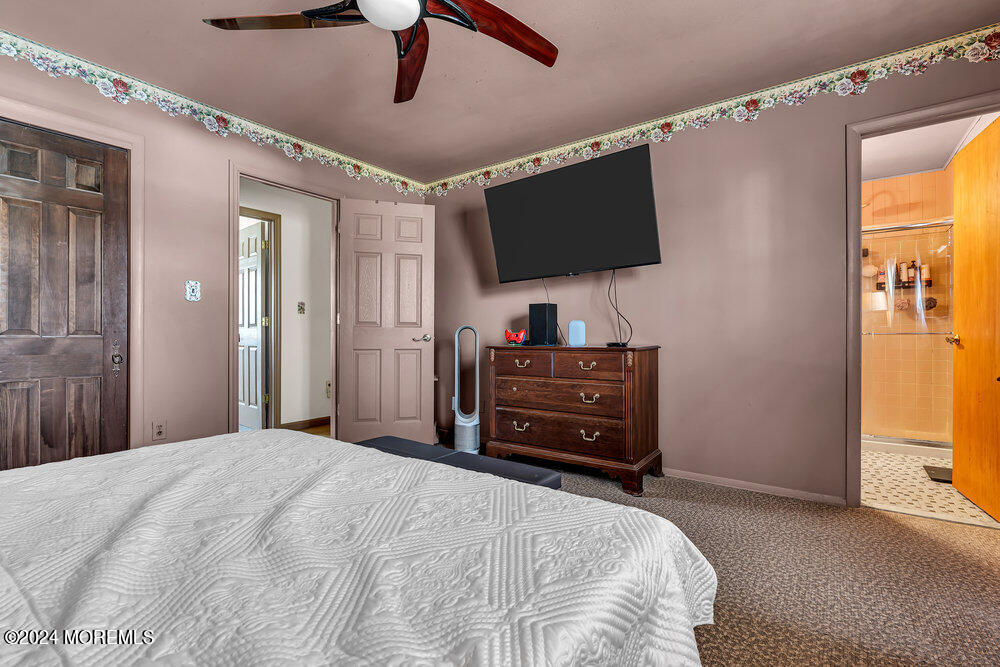 115 Stillwells Corner Road Freehold, NJ 07728 - Photo 27 of 47 a bedroom with a bed and flat screen tv