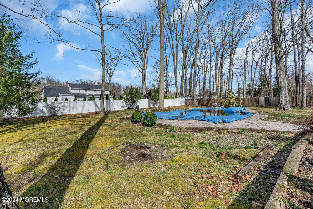 115 Stillwells Corner Road Freehold, NJ 07728 - Photo 38 of 47 a swimming pool with outdoor seating and yard