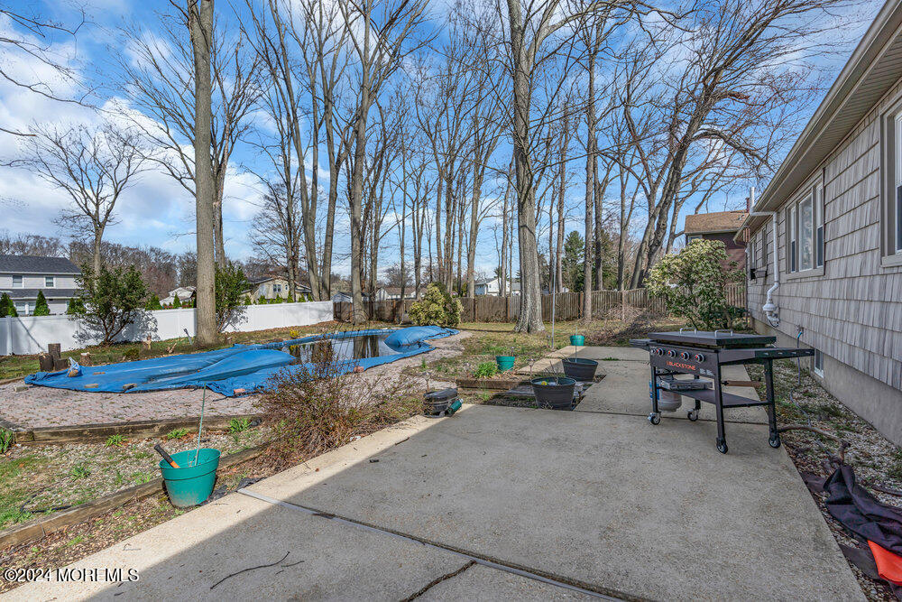 115 Stillwells Corner Road Freehold, NJ 07728 - Photo 39 of 47 a view of a patio with table and chairs with wooden fence and plants
