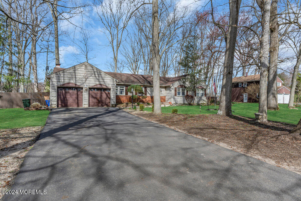 115 Stillwells Corner Road Freehold, NJ 07728 - Photo 4 of 47 a front view of a building with large trees