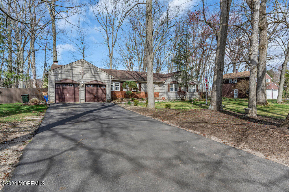 115 Stillwells Corner Road Freehold, NJ 07728 - Photo 45 of 47 a front view of a building with large trees