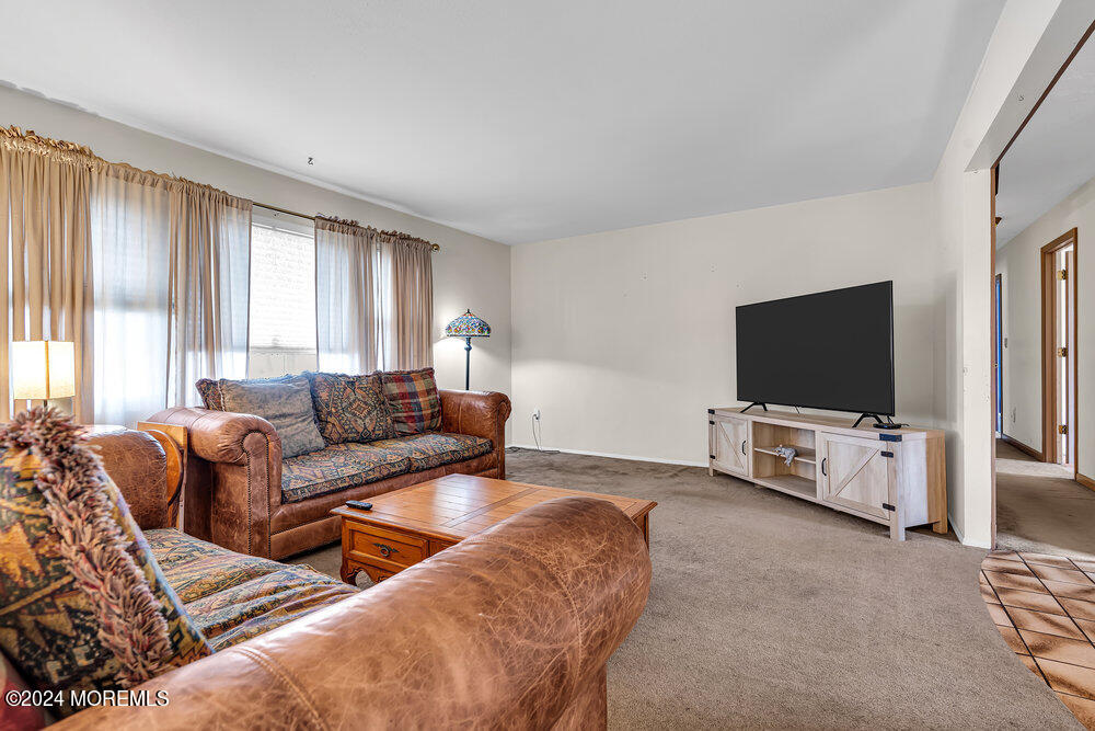 115 Stillwells Corner Road Freehold, NJ 07728 - Photo 8 of 47 a living room with furniture and a flat screen tv