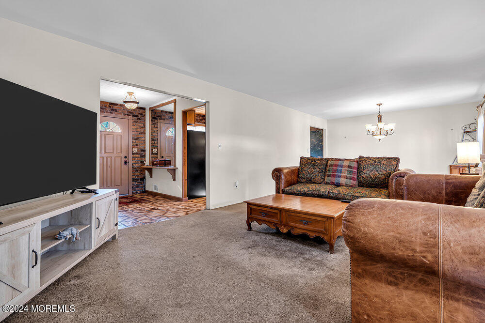 115 Stillwells Corner Road Freehold, NJ 07728 - Photo 10 of 47 a living room with furniture and a flat screen tv
