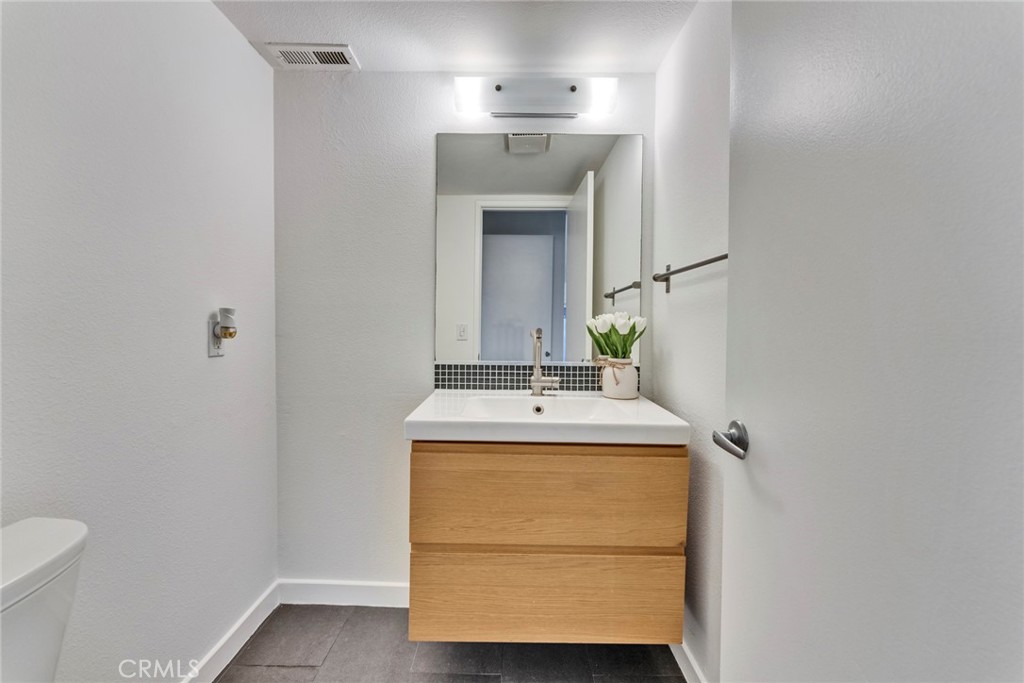 5 Hartford, Unit 36 Irvine, CA 92604 - Photo 18 of 37 a bathroom with a sink and a mirror