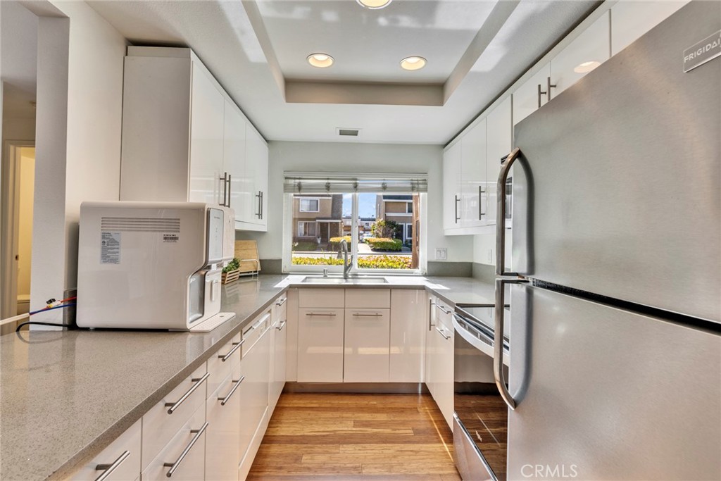 5 Hartford, Unit 36 Irvine, CA 92604 - Photo 9 of 37 a kitchen with counter top space and stainless steel appliances