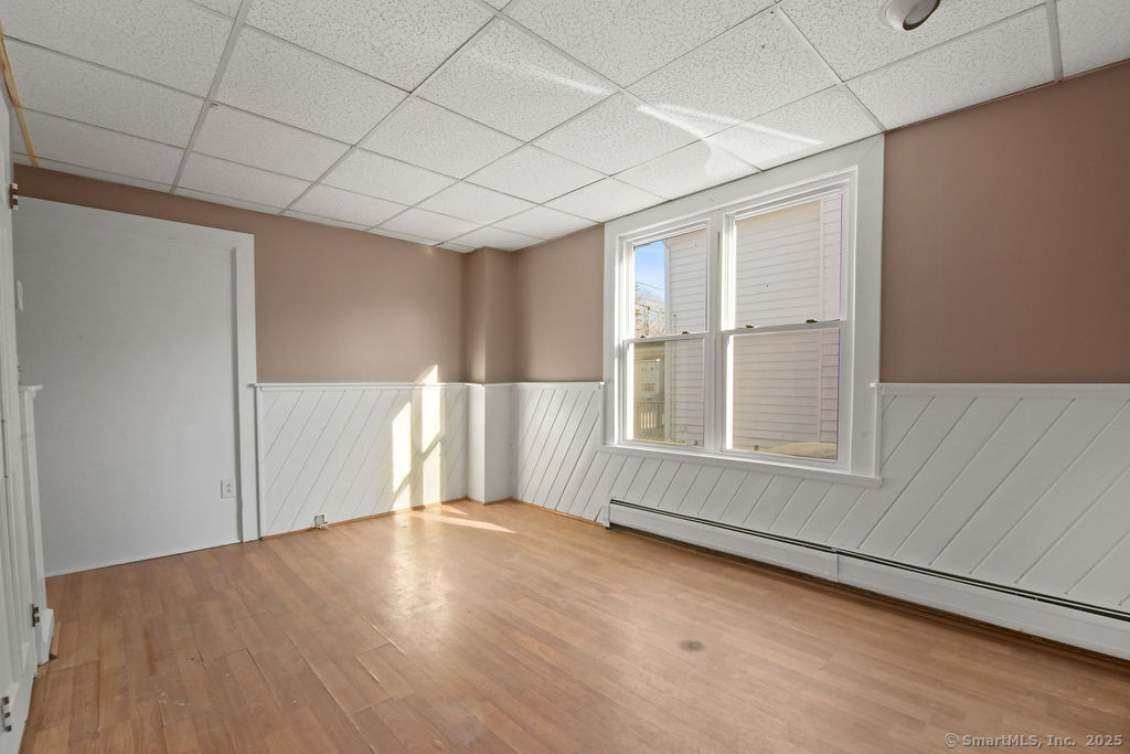 10 Silver Street Middletown, CT 06457 - Photo 14 of 20 an empty room with wooden floor and windows with curtains
