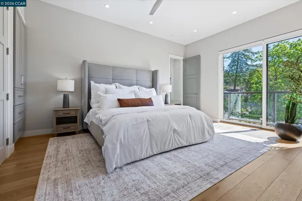 a bedroom with a bed a couch and potted plant