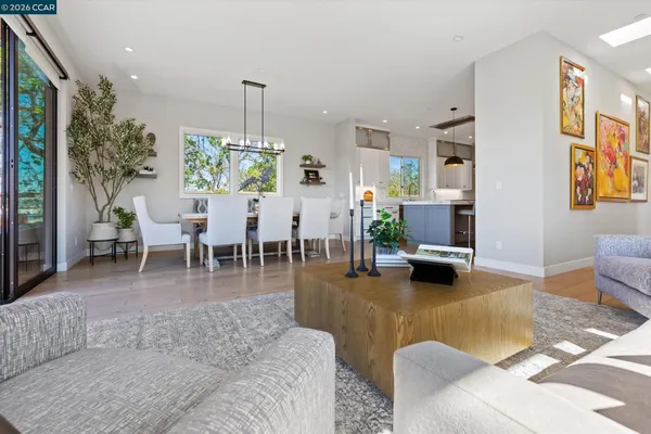 a living room with furniture potted plant and a large window
