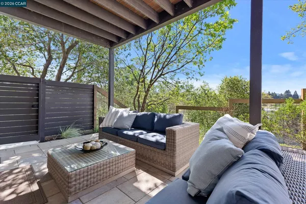 a view of a house with backyard and sitting area