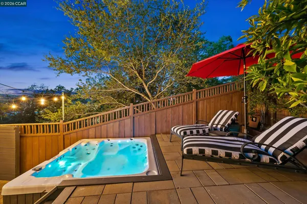 a backyard of a house with table and chairs