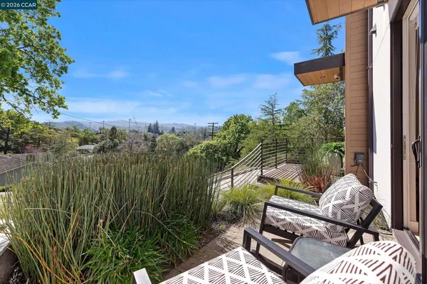 a backyard of a house with lots of green space and outdoor seating