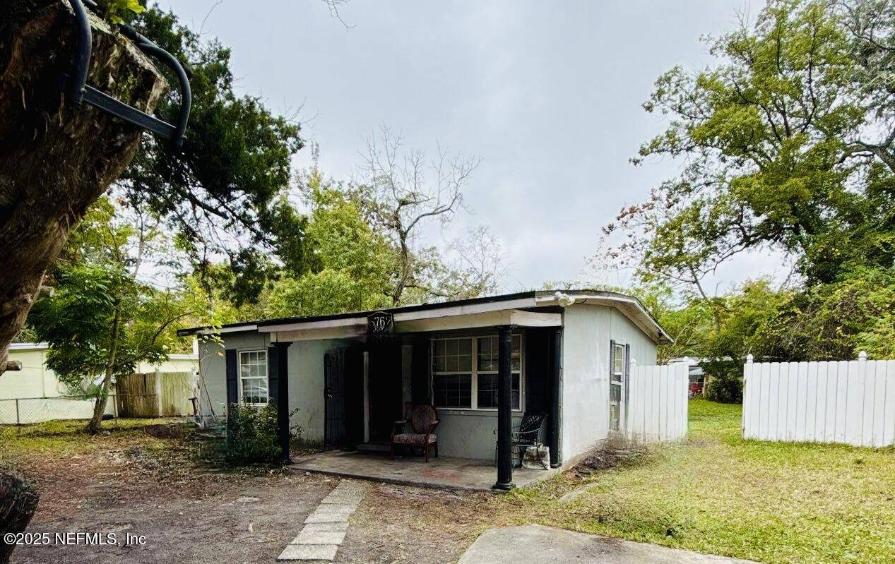 a view of a house with a tree in the background