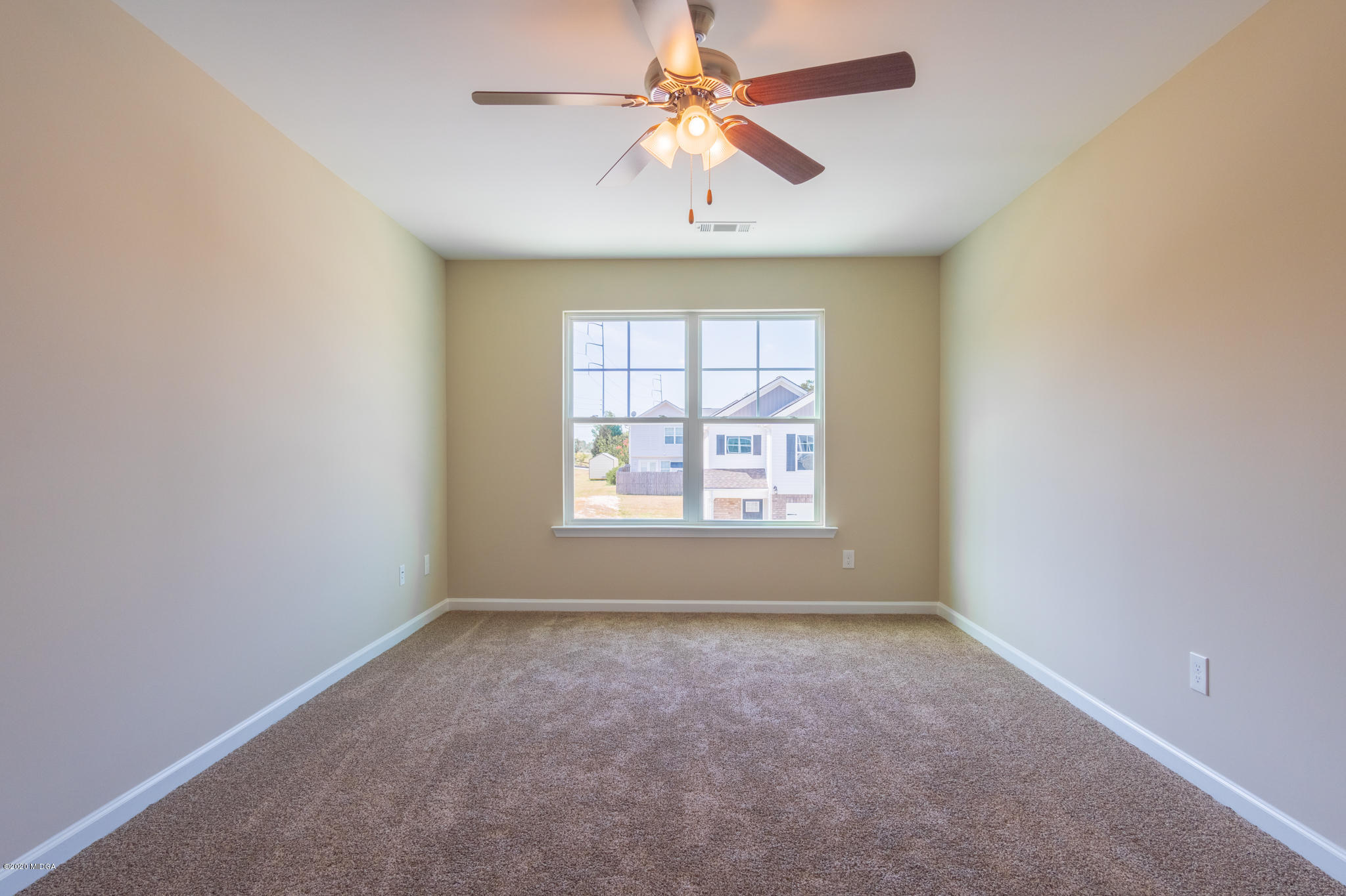 307 Pond View Road Macon, GA 31206 - Photo 14 of 27 an empty room with windows and chandelier fan