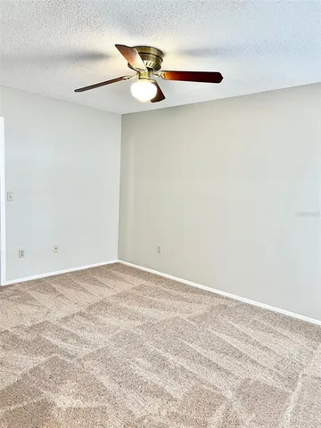 a view of a room with a fan and a window