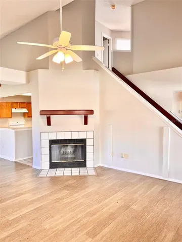 a view of a livingroom with a fireplace and window