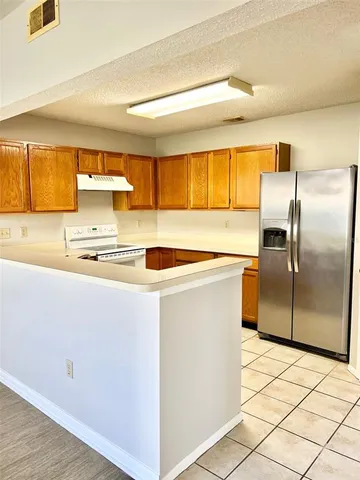 a kitchen with stainless steel appliances a refrigerator sink and cabinets