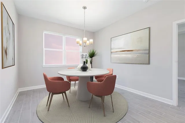 a dining room with furniture a rug and a chandelier