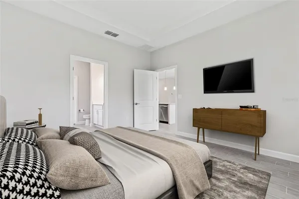 a bedroom with a bed and a flat screen tv