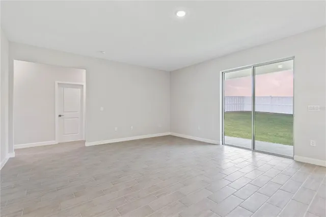 an empty room with sliding glass door