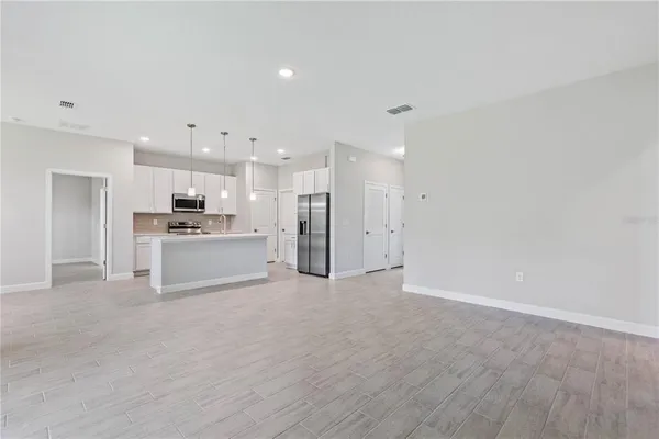 a view of a kitchen with a sink and a refrigerator
