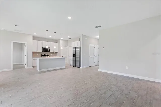 a view of a kitchen with a sink and a refrigerator