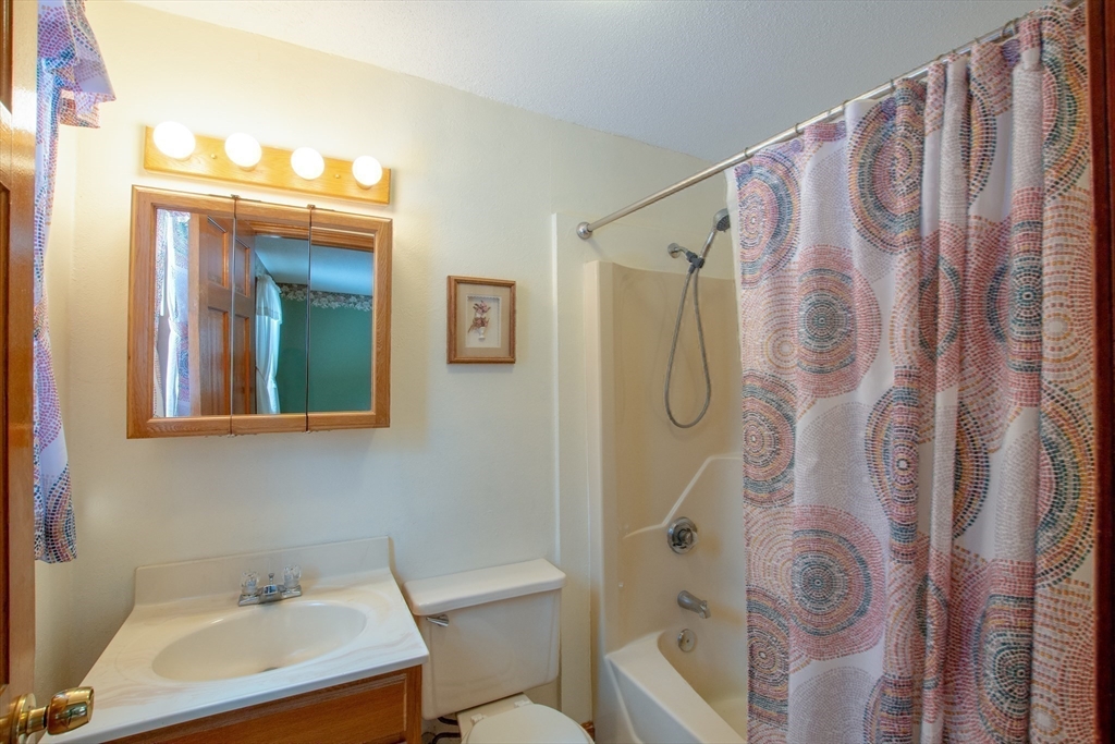 207 Sherbert Road Ashburnham, MA 01430 - Photo 19 of 41 a bathroom with a shower curtain and a sink