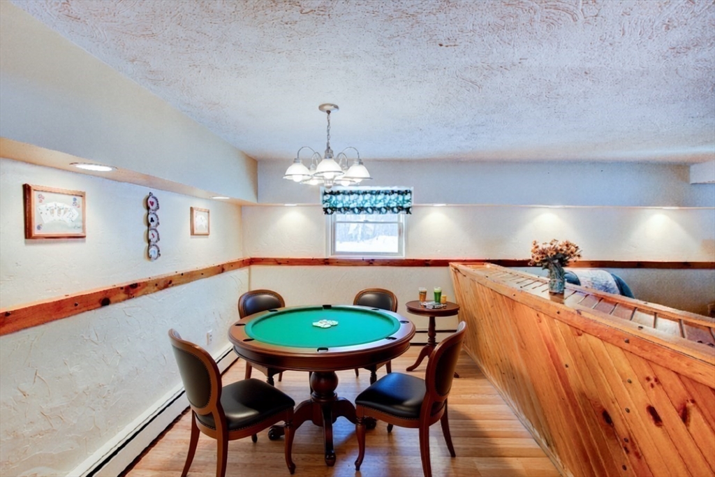 207 Sherbert Road Ashburnham, MA 01430 - Photo 29 of 41 a view of a dining room with furniture wooden floor and chandelier