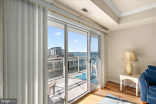 a view of a balcony with chair and floor to ceiling window