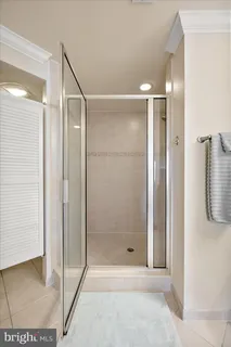 a bathroom with a glass shower door