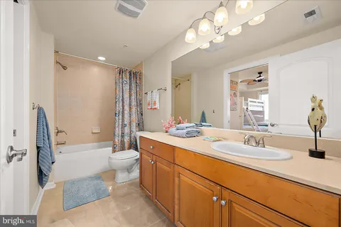 a bathroom with a sink double vanity granite tub and a mirror