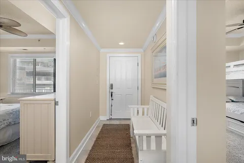 a view of a hallway with wooden floor and entryway