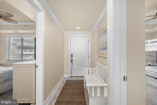 a view of a hallway with wooden floor and entryway