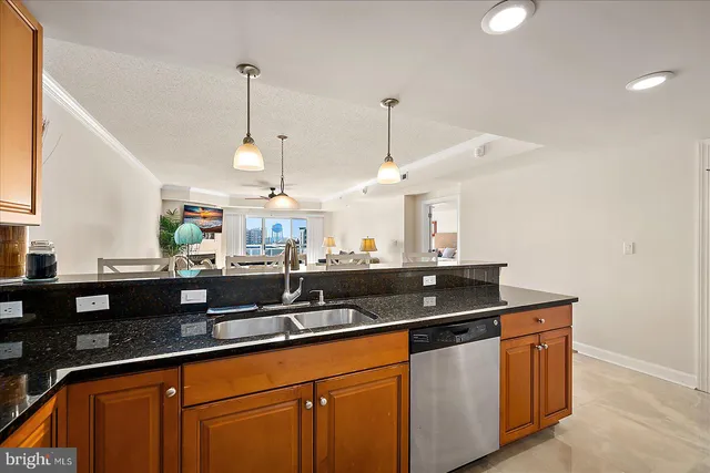 a kitchen with granite countertop a sink and cabinets