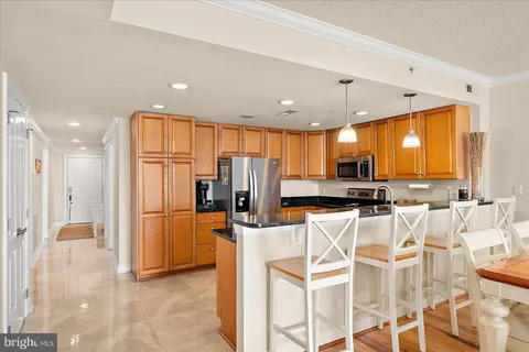 a kitchen with stainless steel appliances a refrigerator and a stove top oven