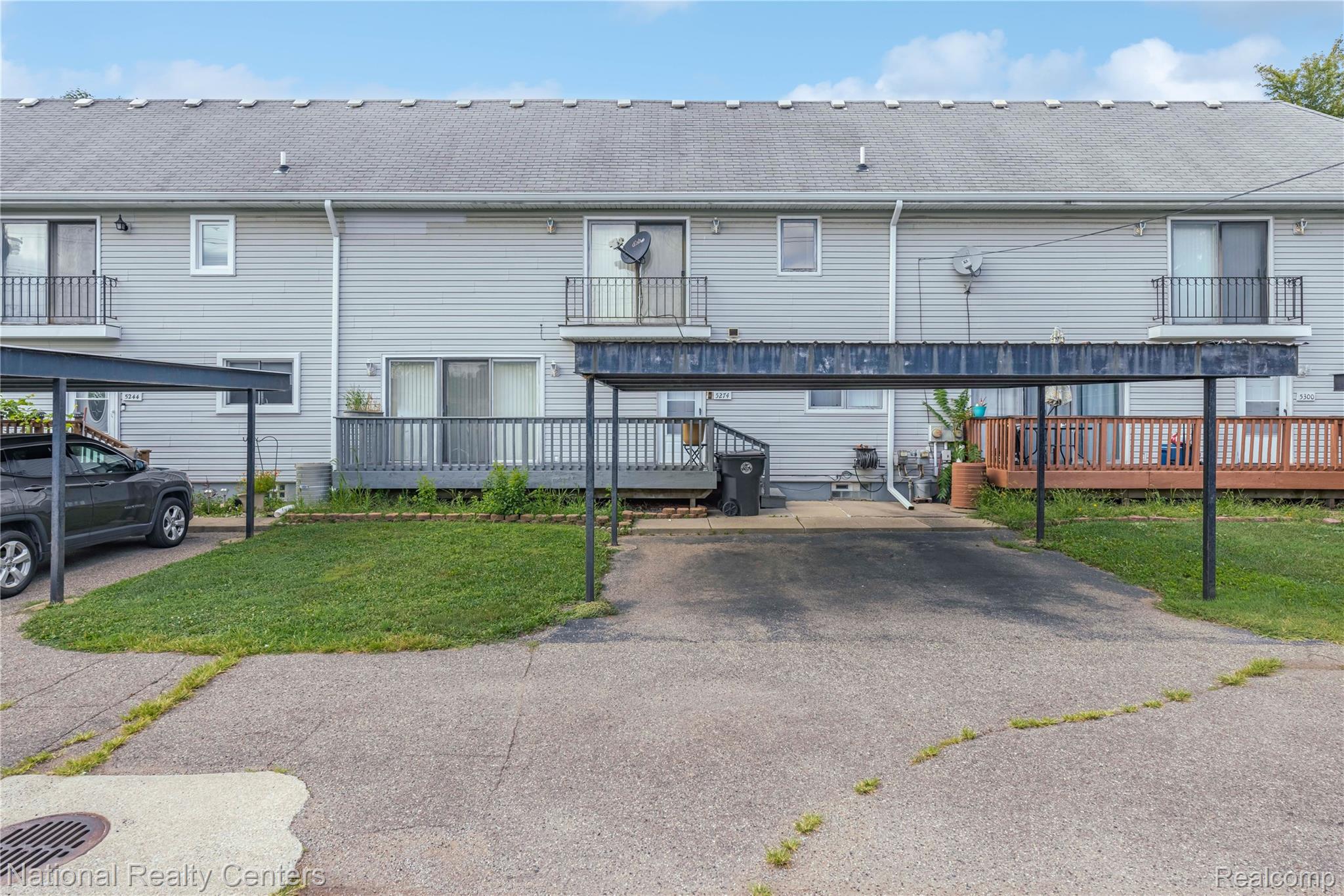 5274 East 14 Mile Road Warren, MI 48092 - Photo 30 of 31 Carport parking, exterior siding, private balcony, and ground-level deck
