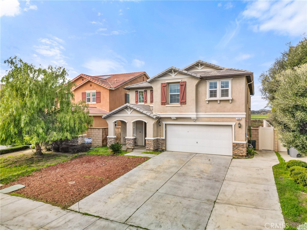 136 Yosemite Avenue Perris, CA 92570 - Photo 1 of 31 a front view of a house with a yard