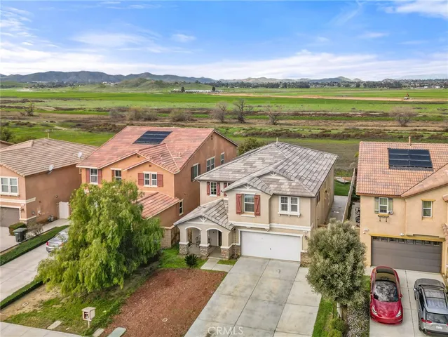 an aerial view of residential houses with outdoor space and ocean view