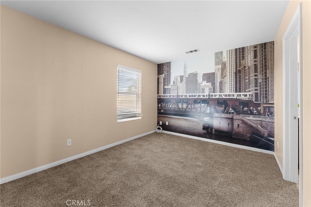 136 Yosemite Avenue Perris, CA 92570 - Photo 24 of 31 a view of an empty room with a window