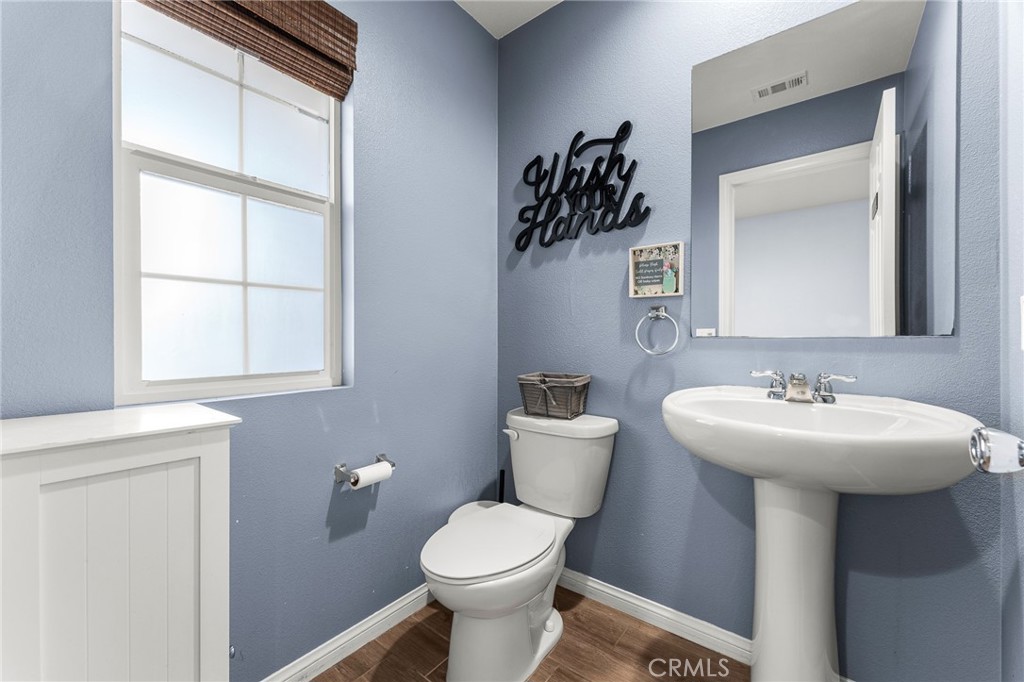 136 Yosemite Avenue Perris, CA 92570 - Photo 25 of 31 a bathroom with a sink toilet and mirror