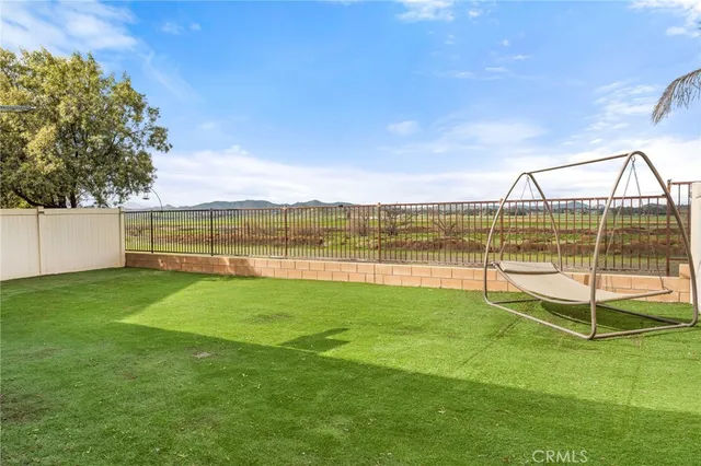 a view of yard with swimming pool and green space
