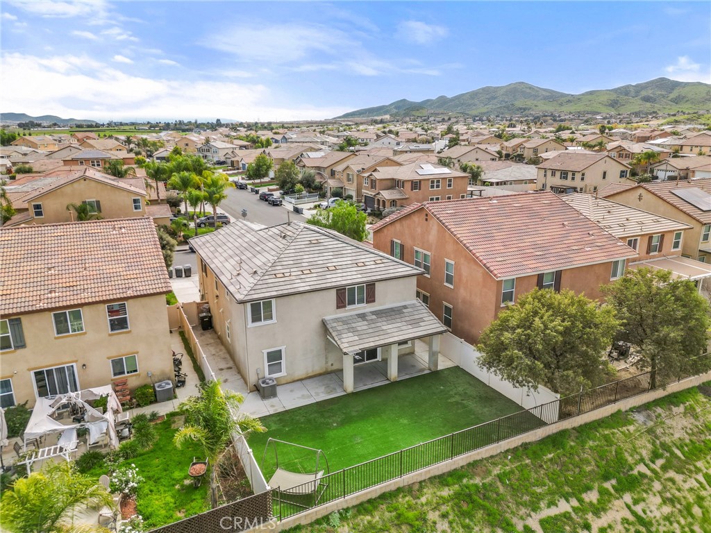 136 Yosemite Avenue Perris, CA 92570 - Photo 3 of 31 an aerial view of residential houses with outdoor space and trees