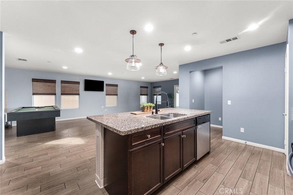 136 Yosemite Avenue Perris, CA 92570 - Photo 8 of 31 a kitchen with a stove and a wooden floor