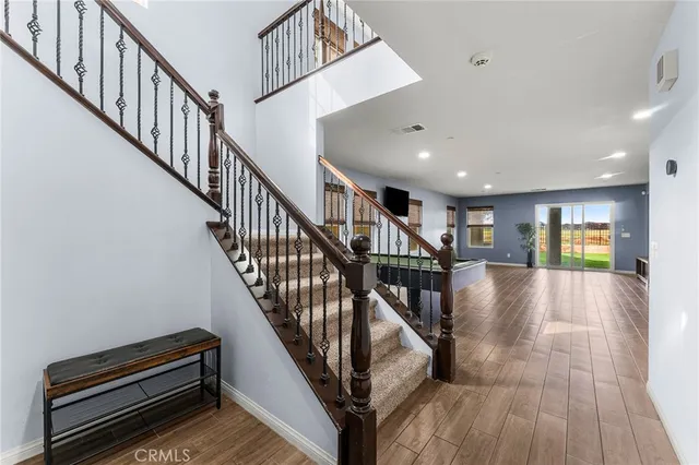 a view of entryway and hall with wooden floor