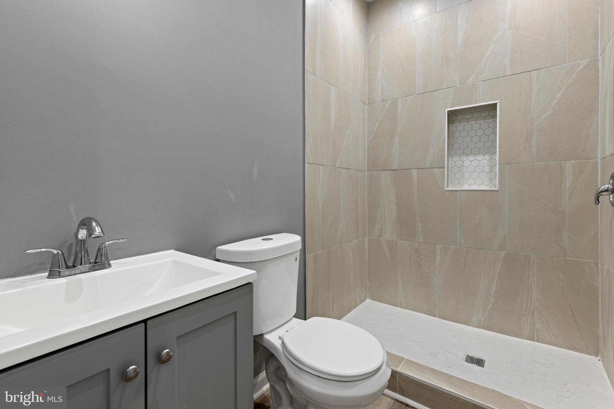 1809 West Lombard Street Baltimore, MD 21223 - Photo 11 of 36 a bathroom with a sink a toilet and shower