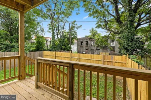 a view of a balcony with yard