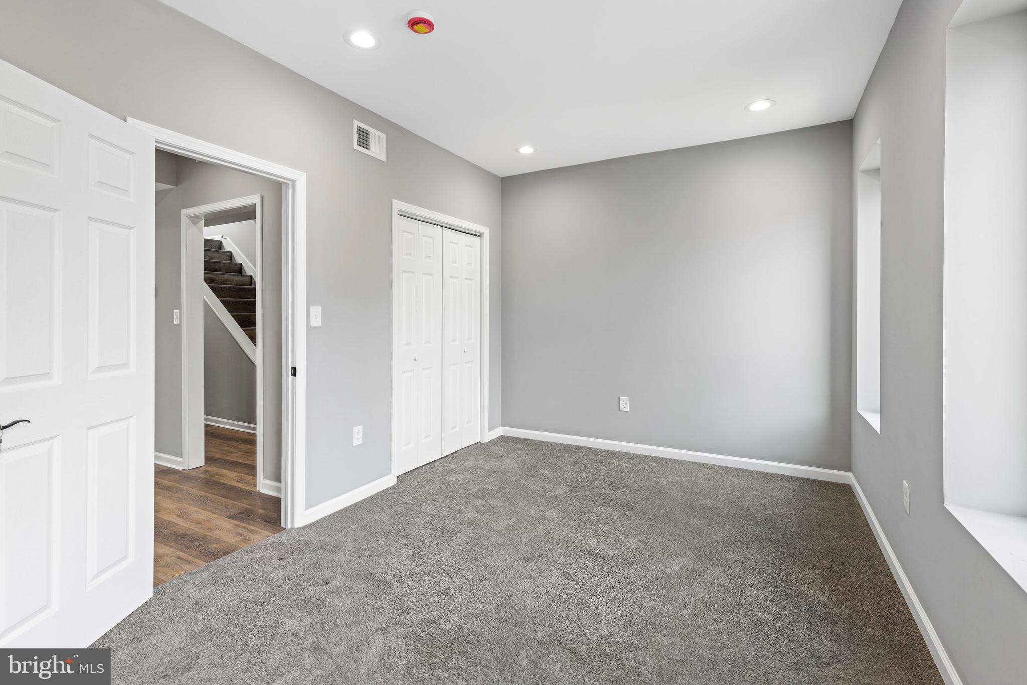 1809 West Lombard Street Baltimore, MD 21223 - Photo 15 of 36 an empty room with closet and wooden door